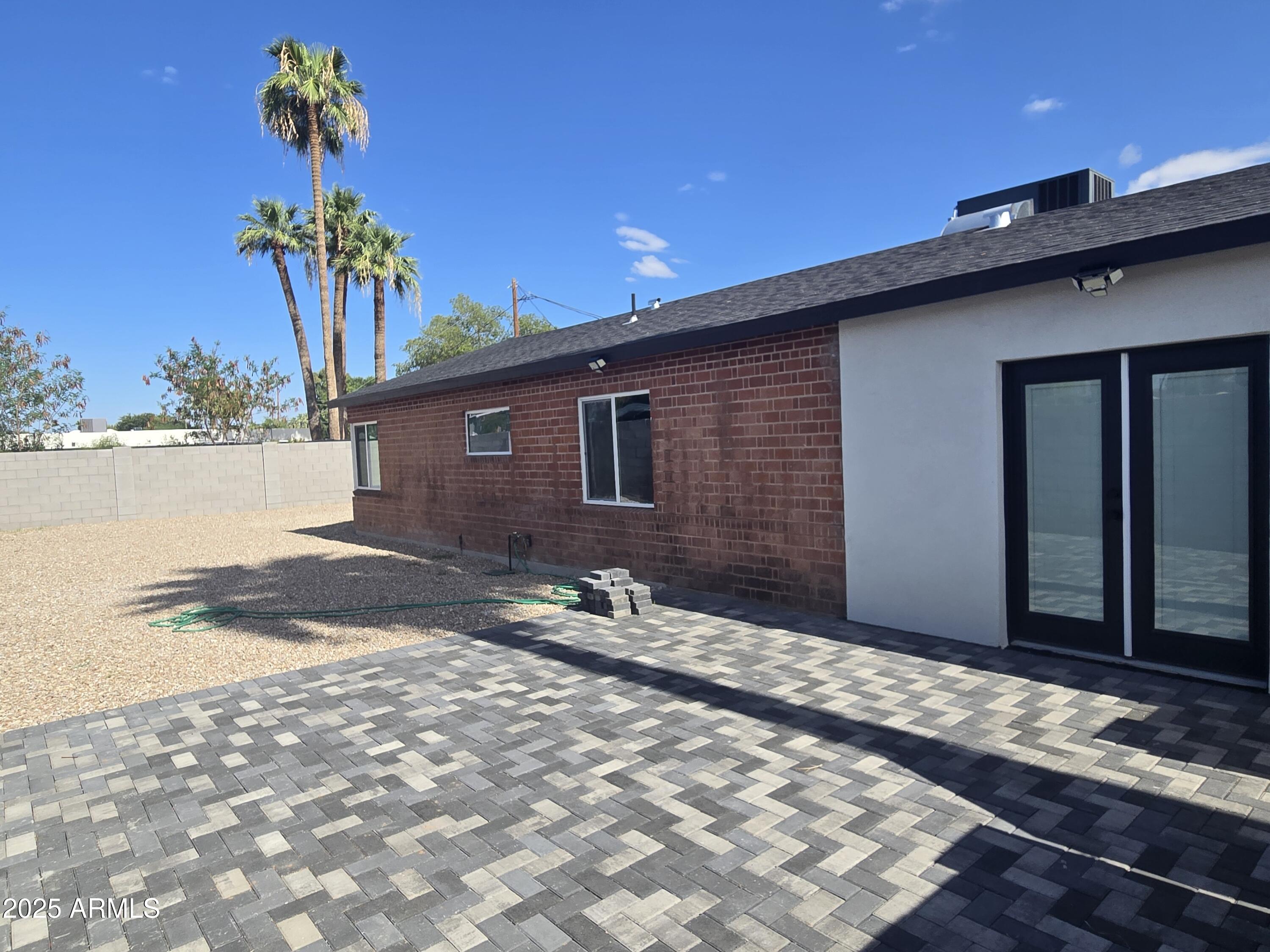 3241 North 27th Place Phoenix, AZ 85016 - Photo 10 of 25 a backyard of a house with table and chairs