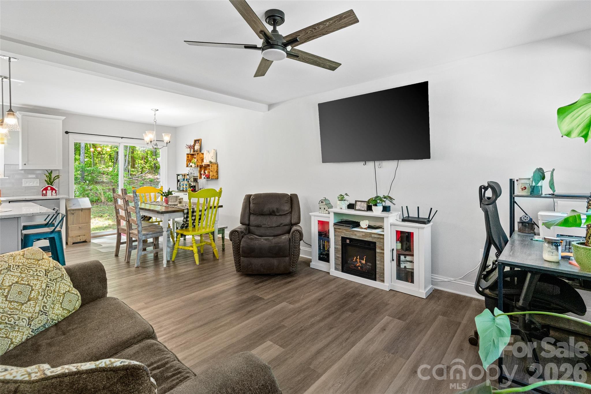 3690 Innes Lane Maiden, NC 28650 - Photo 11 of 34 a living room with furniture a flat screen tv and a floor to ceiling window