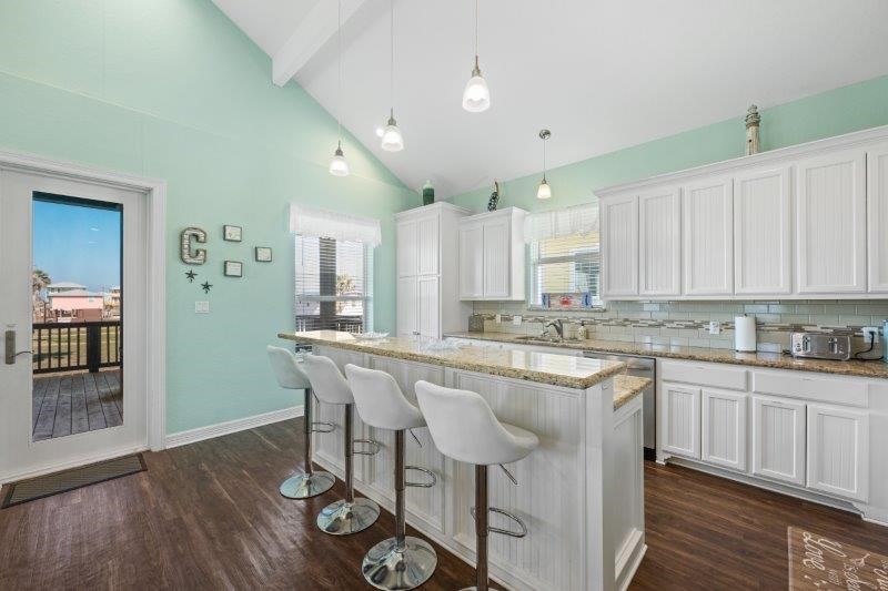 343 Jettyview Road Freeport, TX 77541 - Photo 13 of 44 a kitchen with stainless steel appliances granite countertop a table chairs sink and cabinets