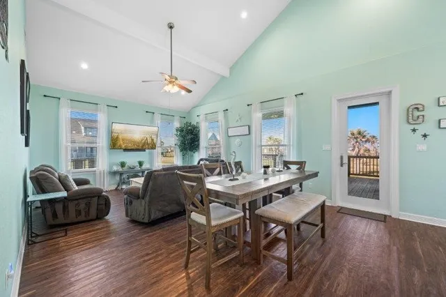 a living room with furniture a window and a flat screen tv