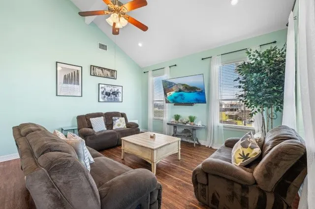 a living room with furniture a chandelier and a window