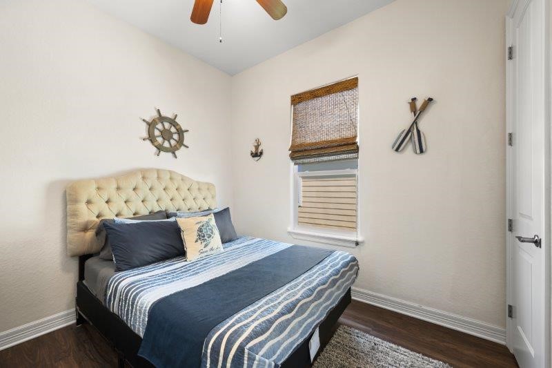 343 Jettyview Road Freeport, TX 77541 - Photo 19 of 44 a bedroom with a bed and a chandelier
