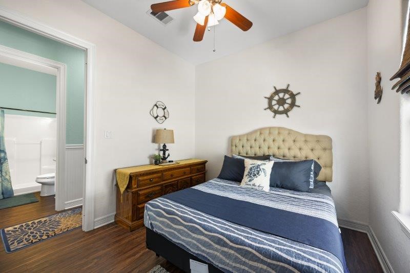 343 Jettyview Road Freeport, TX 77541 - Photo 20 of 44 a bedroom with a bed and wooden floor