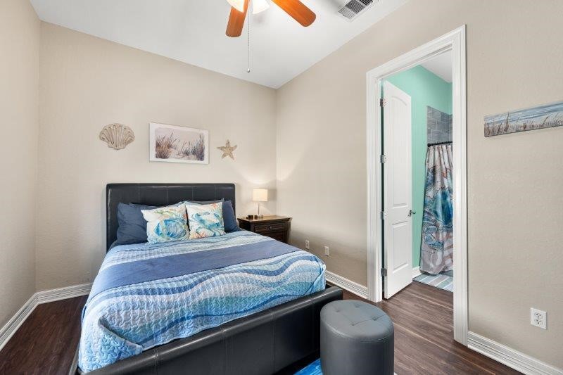 343 Jettyview Road Freeport, TX 77541 - Photo 23 of 44 a bedroom with a bed and wooden floor