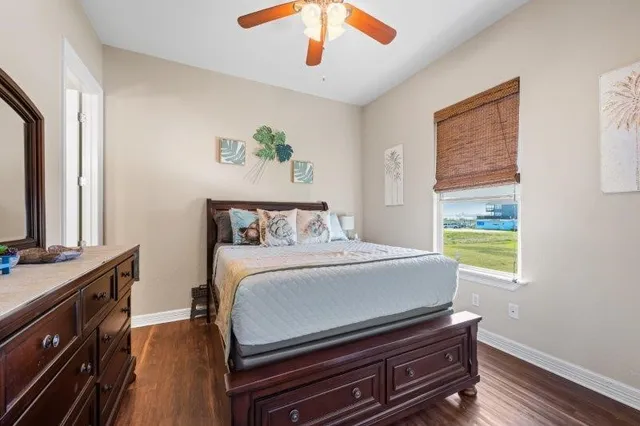 a bedroom with a bed and wooden floor