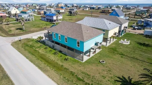 an aerial view of a house with a yard