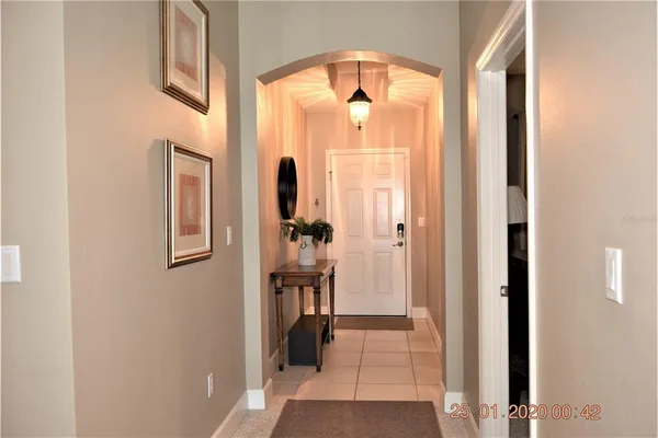 a view of hallway with livingroom and wooden floor