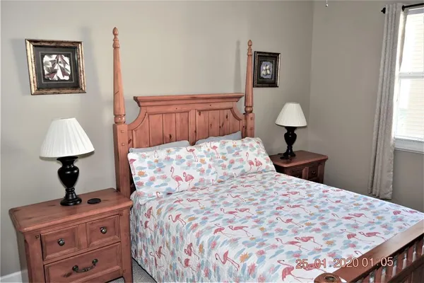 a bedroom with a bed and a lamp on table