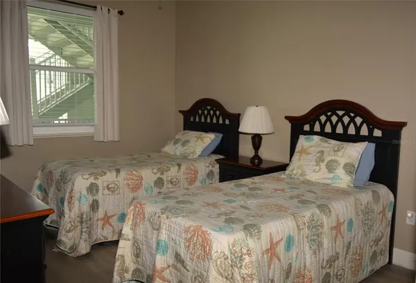 a large bed sitting in a bedroom next to a window
