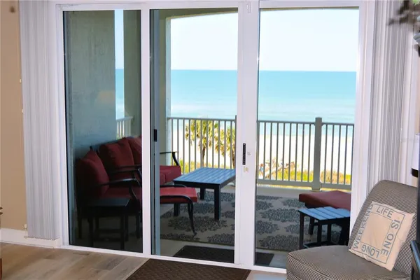 a view of a balcony with furniture and a window
