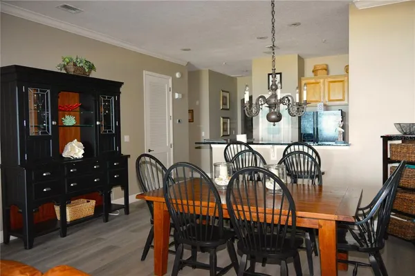 a view of a dining room and kitchen with furniture window and wooden floor