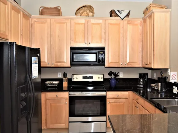 a kitchen with stainless steel appliances a stove a microwave and cabinets
