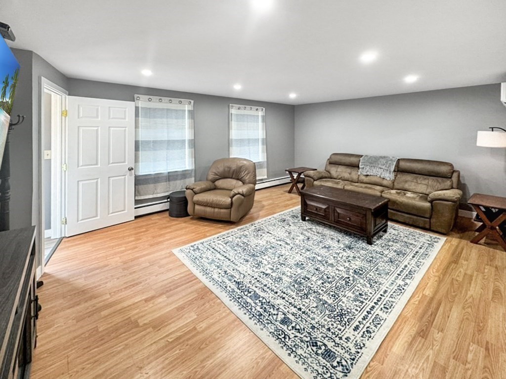 3 Maple Ridge Road, Unit 3 Seabrook, NH 03874 - Photo 7 of 26 a living room with furniture and a rug