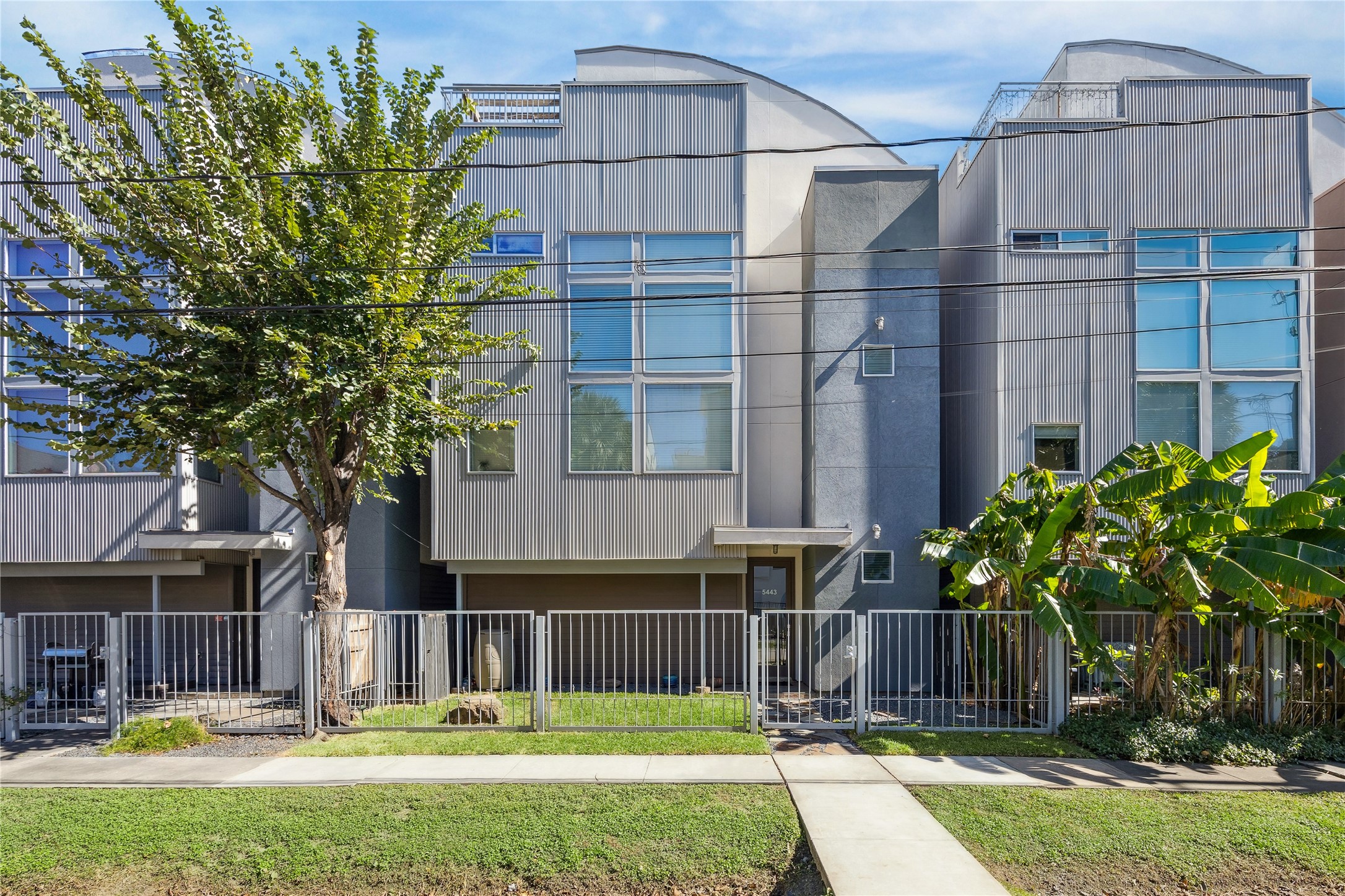 a front view of building with yard and green space