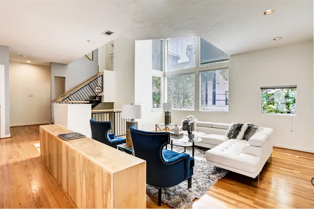 a living room with furniture and wooden floor