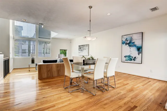 a living room with furniture a wooden floor and a chandelier