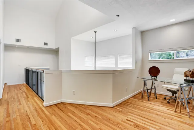 a view of dining room kitchen with stainless steel appliances wooden floor and chair