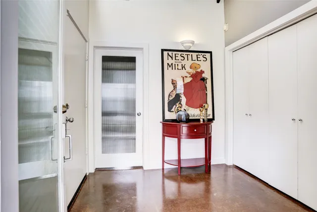 a view of a hallway with wooden floor and closet