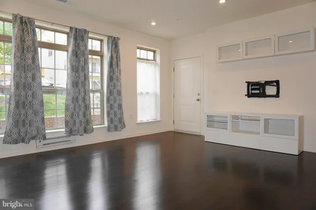 a view of wooden floor and windows in a room