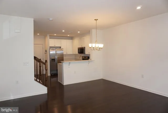 a view of kitchen with stainless steel appliances refrigerator oven and cabinets