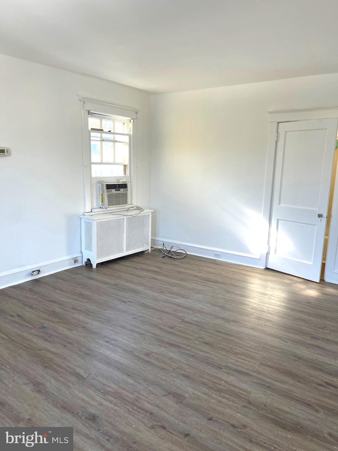 319 Simms Street, Unit 2 Philadelphia, PA 19116 - Photo 15 of 23 an empty room with wooden floor and windows