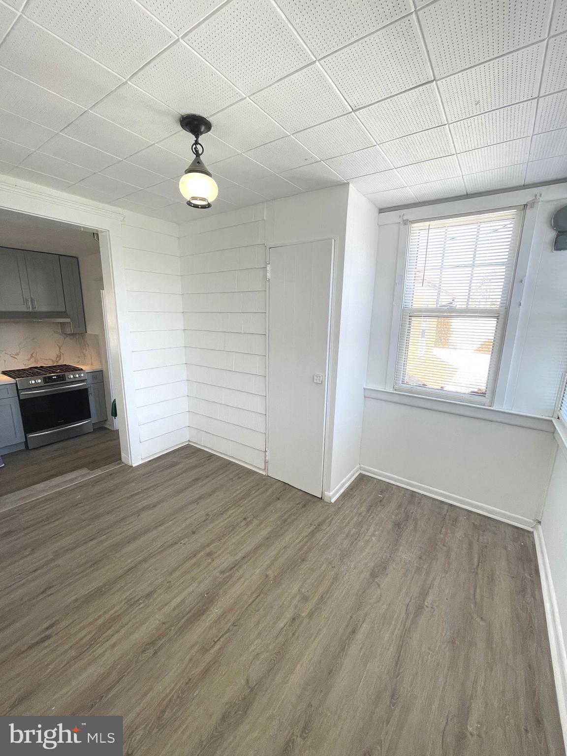 319 Simms Street, Unit 2 Philadelphia, PA 19116 - Photo 9 of 23 an empty room with wooden floor cabinet and windows