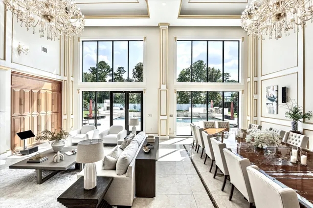 a living room with furniture and large windows