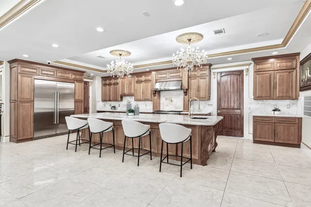 a view of a dining room with furniture and chandelier