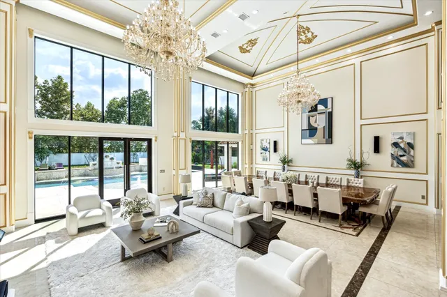 a living room with furniture and large windows