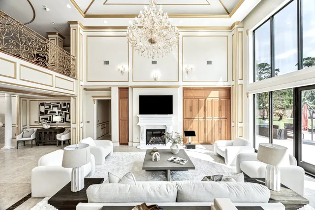 a living room with furniture fireplace and a large window