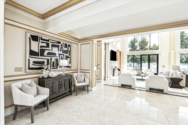 a living room with furniture and large windows