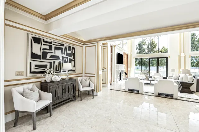 a living room with furniture and large windows