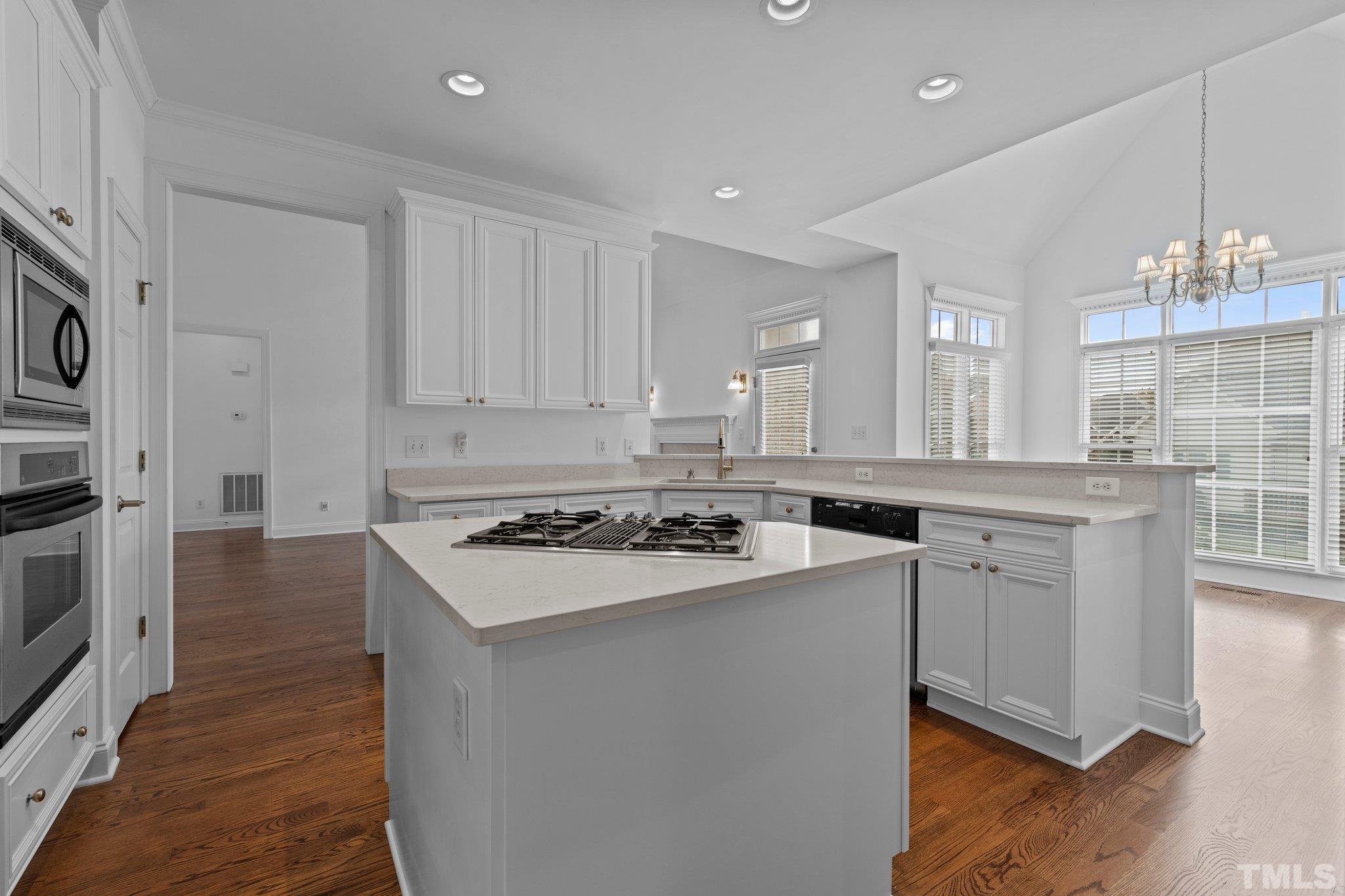 4800 Patton Ridge Court Raleigh, NC 27612 - Photo 11 of 61 a kitchen with a stove a sink and a refrigerator
