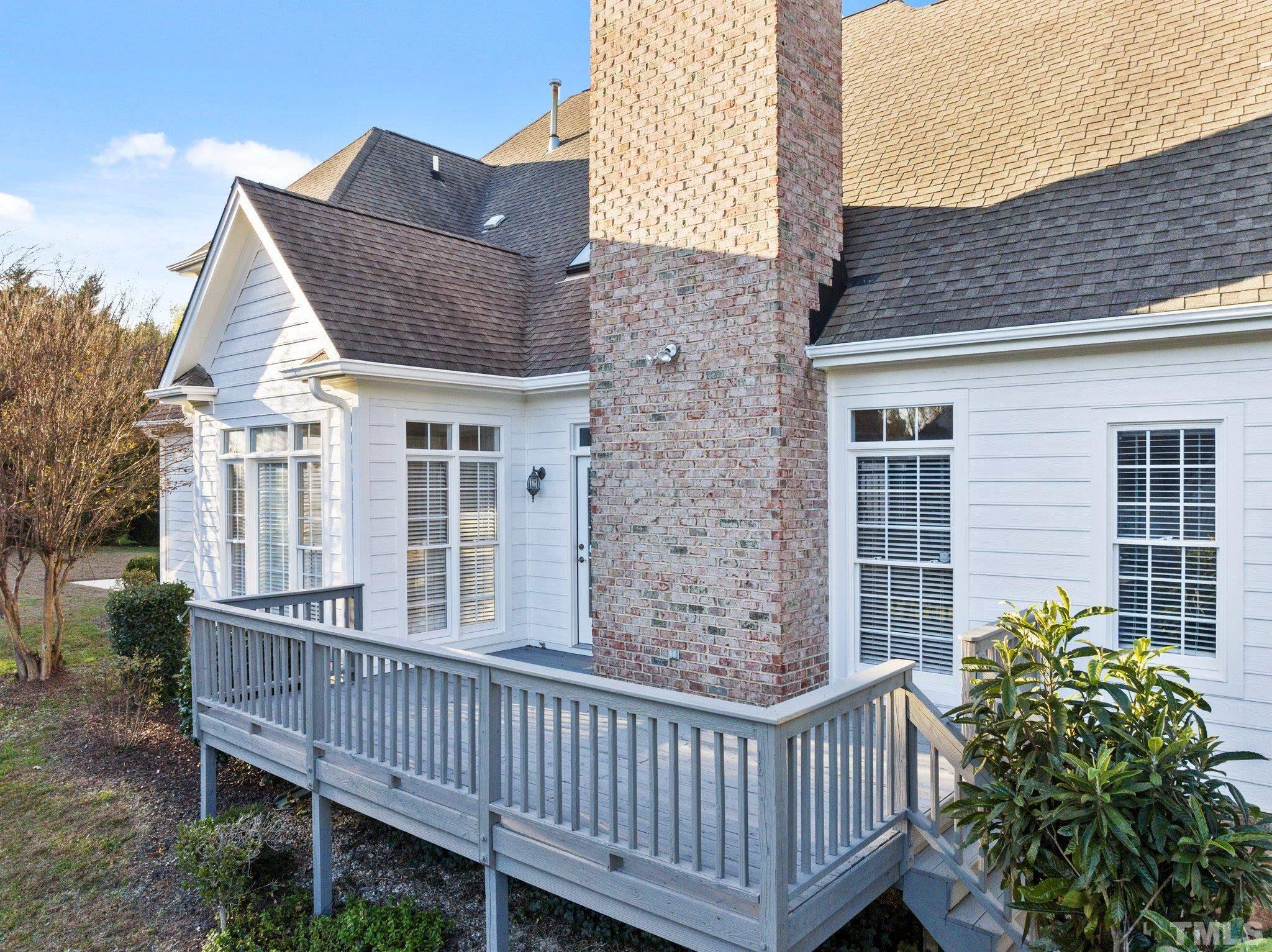 4800 Patton Ridge Court Raleigh, NC 27612 - Photo 21 of 61 a porch with a bench next to a yard