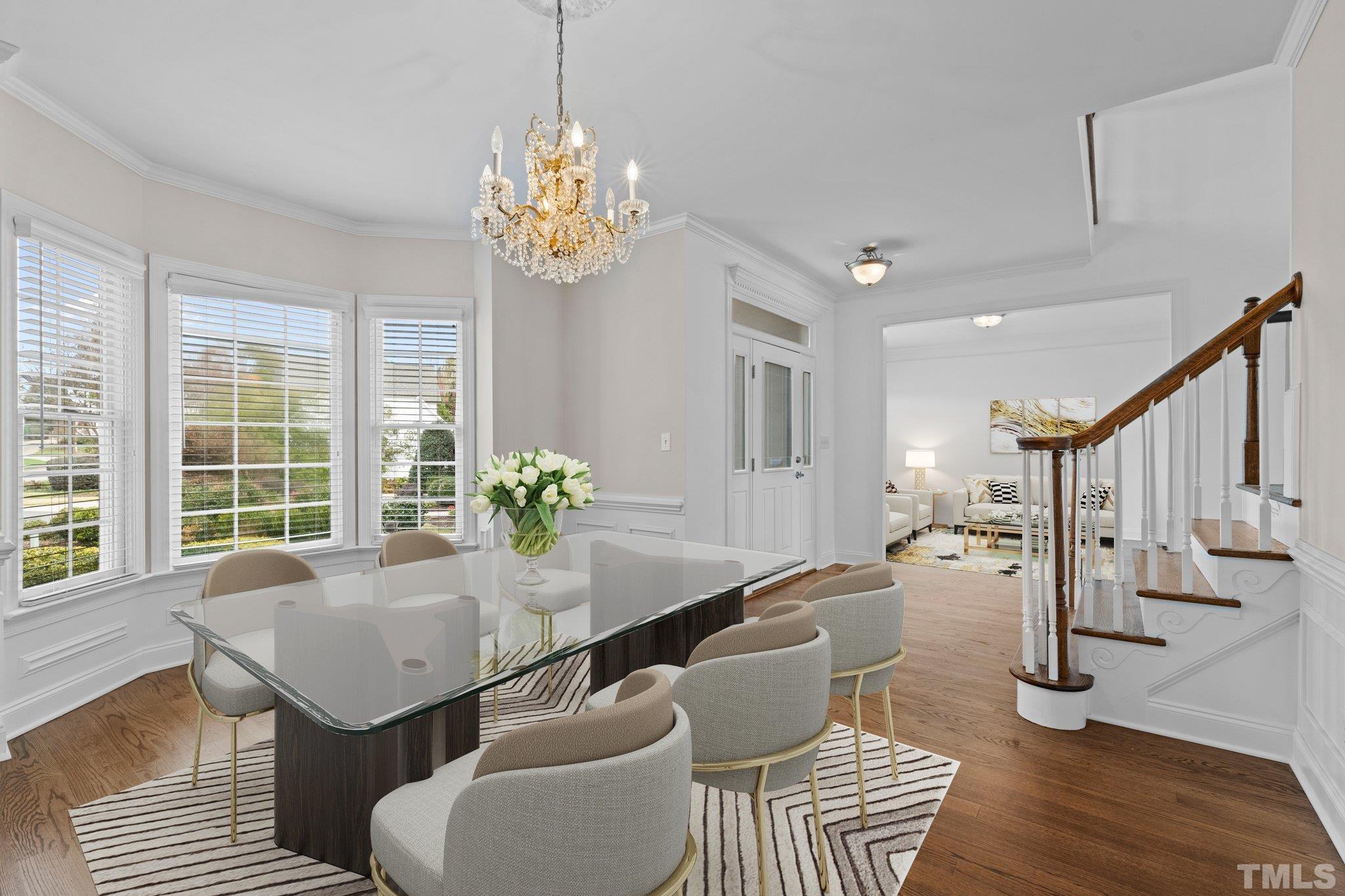4800 Patton Ridge Court Raleigh, NC 27612 - Photo 3 of 61 a view of a dining room with furniture a chandelier and wooden floor