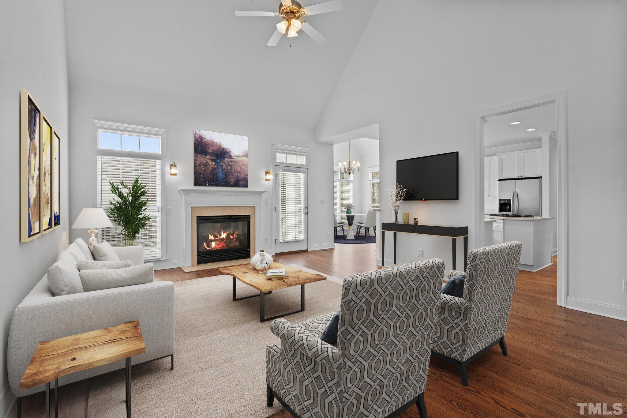 4800 Patton Ridge Court Raleigh, NC 27612 - Photo 4 of 61 a living room with furniture a fireplace and a flat screen tv
