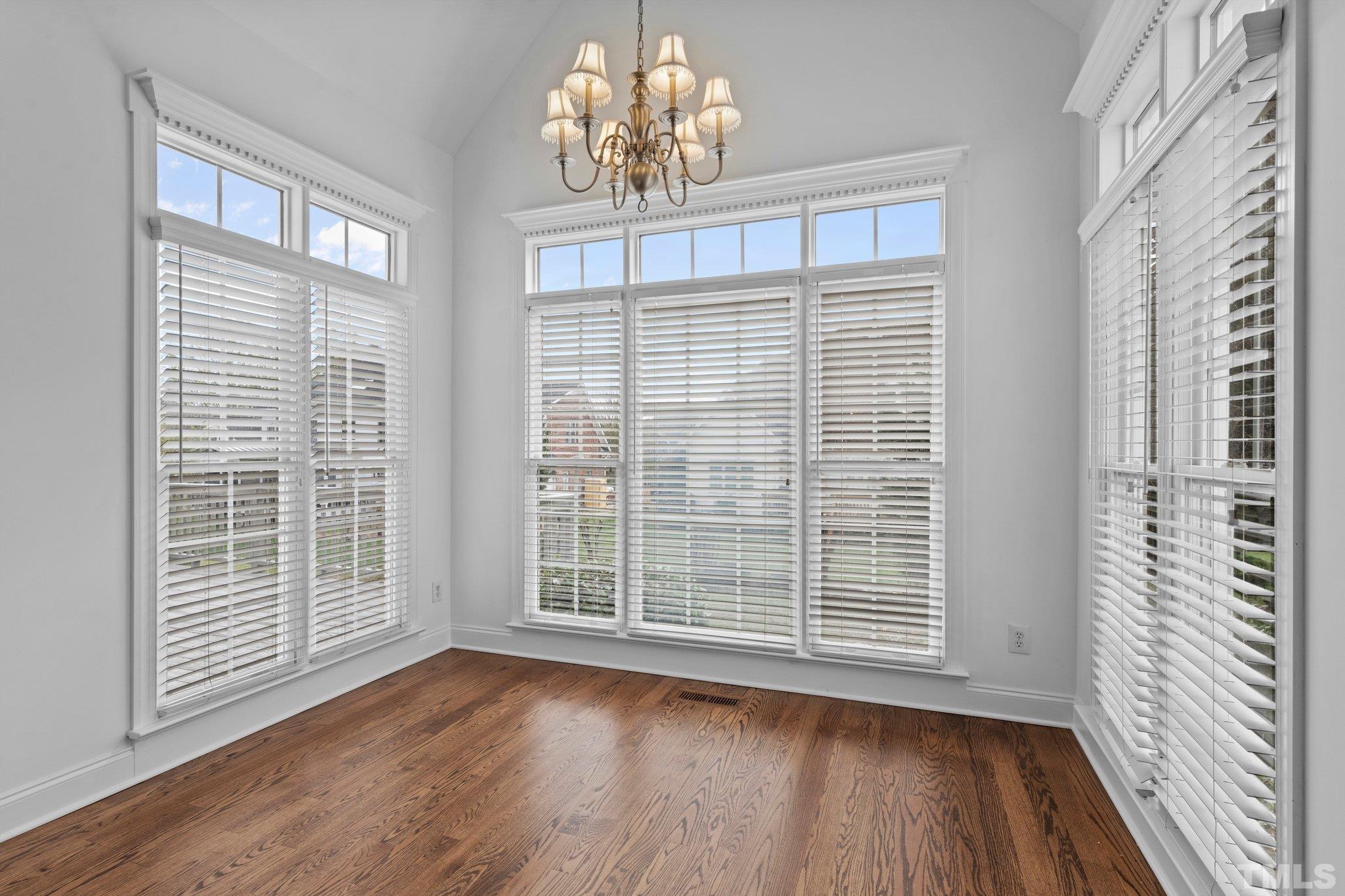 4800 Patton Ridge Court Raleigh, NC 27612 - Photo 41 of 61 a view of a livingroom with wooden floor and a chandelier