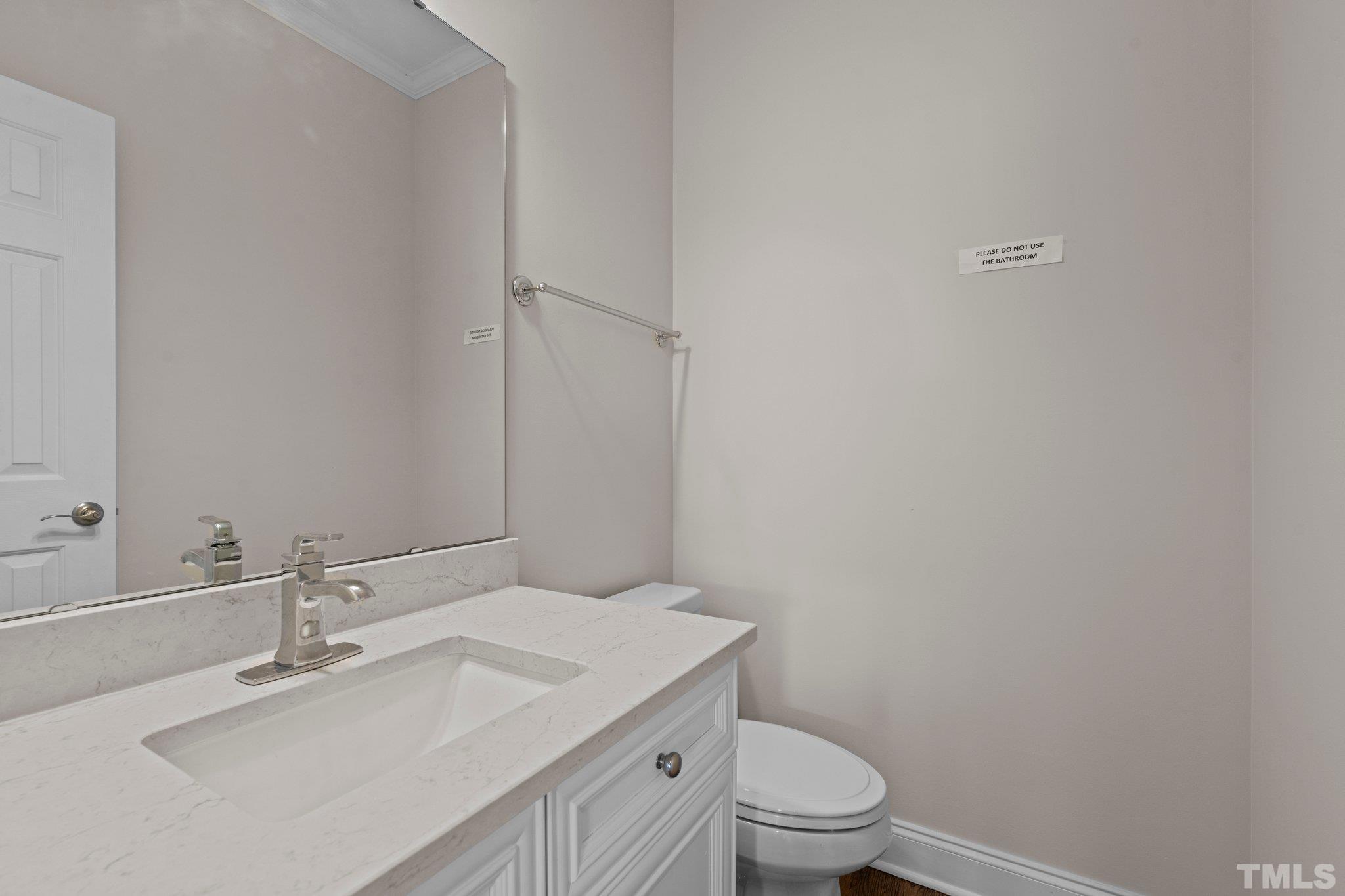 4800 Patton Ridge Court Raleigh, NC 27612 - Photo 42 of 61 a bathroom with a sink a toilet and a mirror