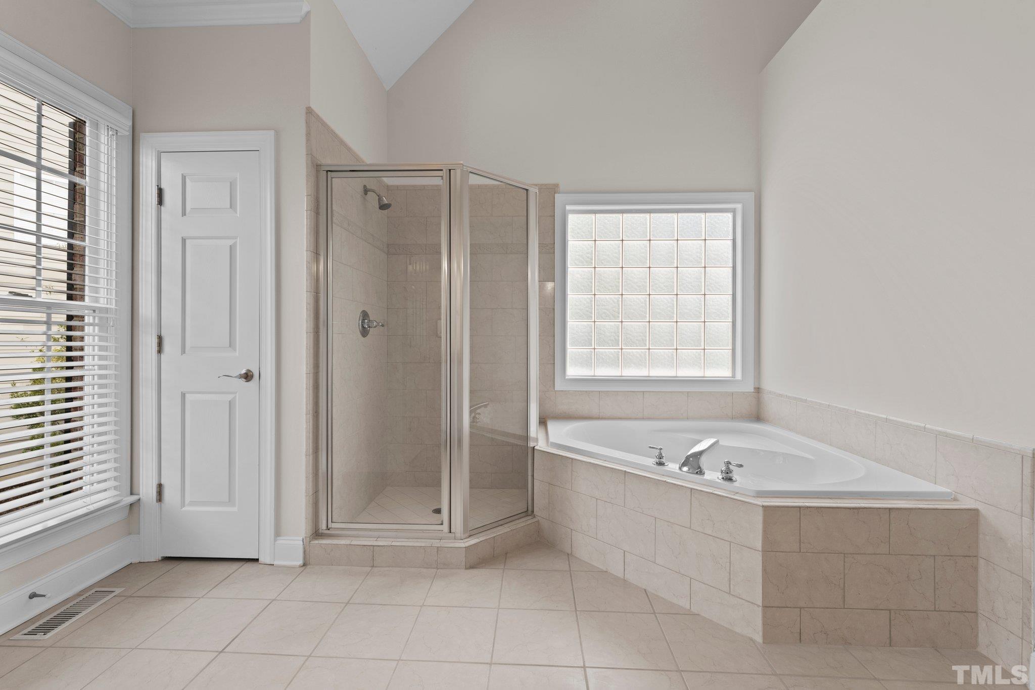 4800 Patton Ridge Court Raleigh, NC 27612 - Photo 52 of 61 a spacious bathroom with a tub shower and window