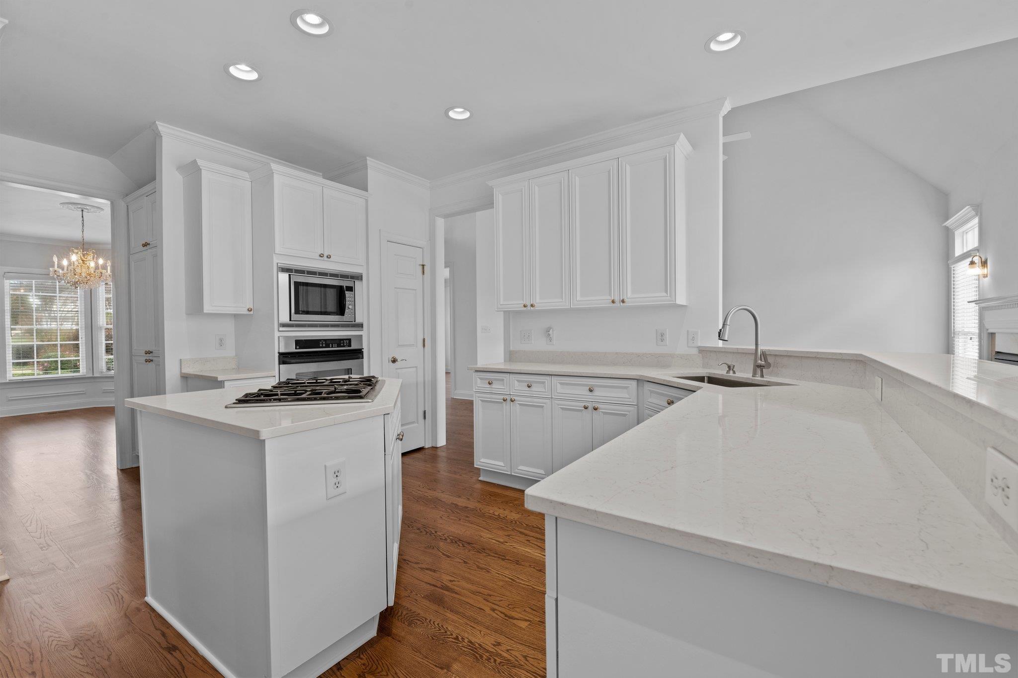 4800 Patton Ridge Court Raleigh, NC 27612 - Photo 9 of 61 a kitchen with stainless steel appliances a sink stove and white cabinets