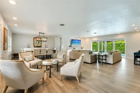 a kitchen with stainless steel appliances a stove top oven a sink dishwasher and a refrigerator