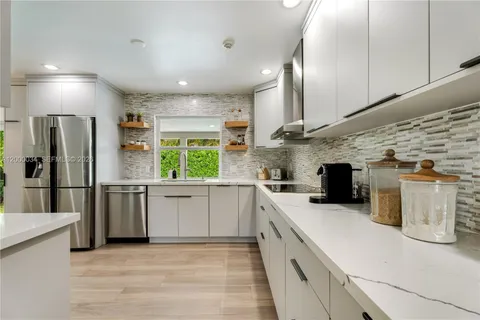 a kitchen with a sink and a large window