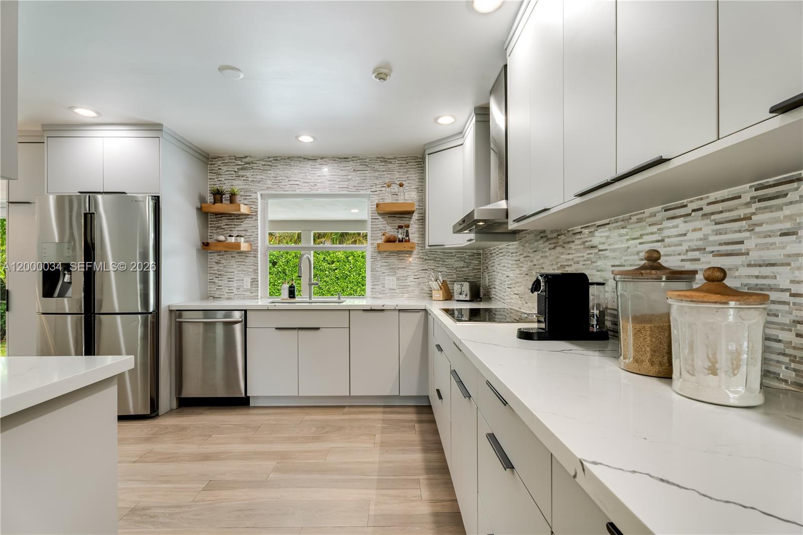 9511 Southwest 93rd Street Miami, FL 33176 - Photo 19 of 56 a kitchen with a sink stainless steel appliances wooden floor and a window