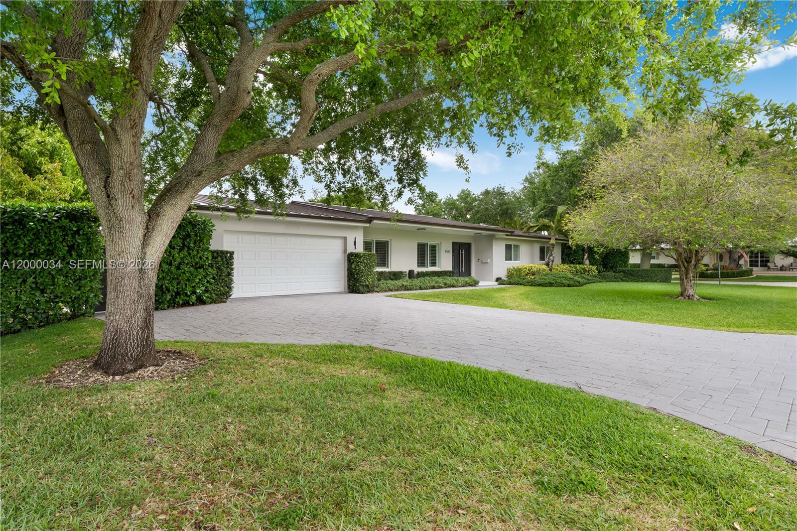 9511 Southwest 93rd Street Miami, FL 33176 - Photo 2 of 56 a front view of a house with yard and green space