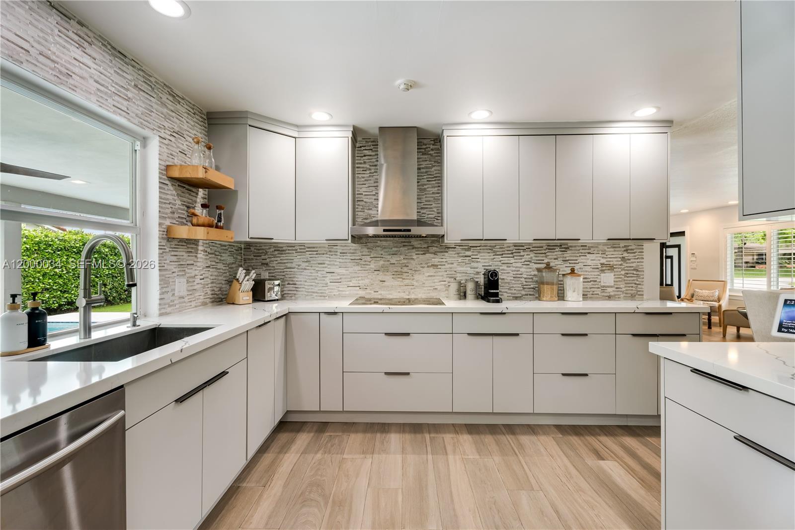 9511 Southwest 93rd Street Miami, FL 33176 - Photo 21 of 56 a kitchen with granite countertop white cabinets white appliances a sink and a large window