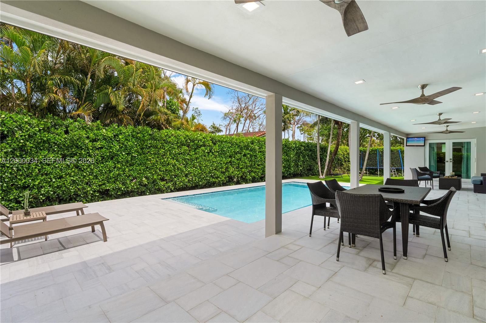 9511 Southwest 93rd Street Miami, FL 33176 - Photo 26 of 56 a dining room with furniture and a floor to ceiling window