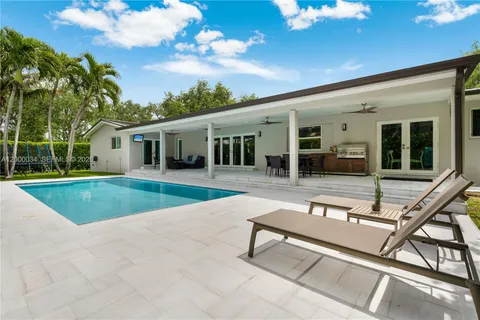 a bathroom with a double vanity sink a toilet a mirror and shower