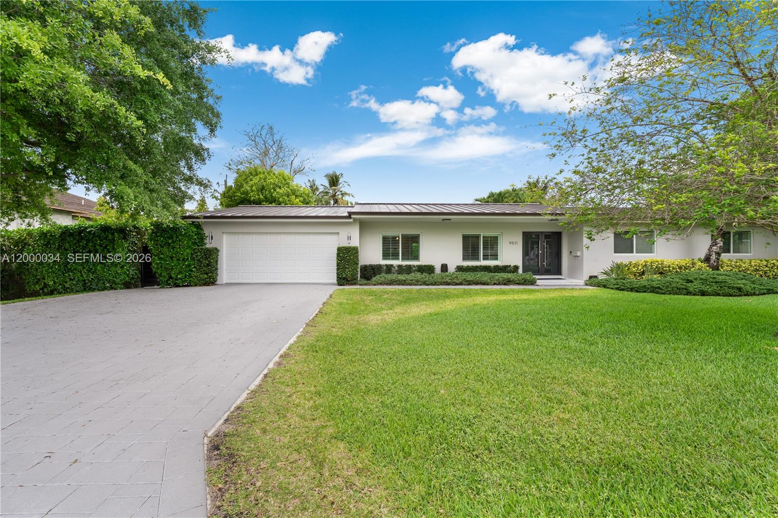 9511 Southwest 93rd Street Miami, FL 33176 - Photo 3 of 56 a front view of a house with a yard