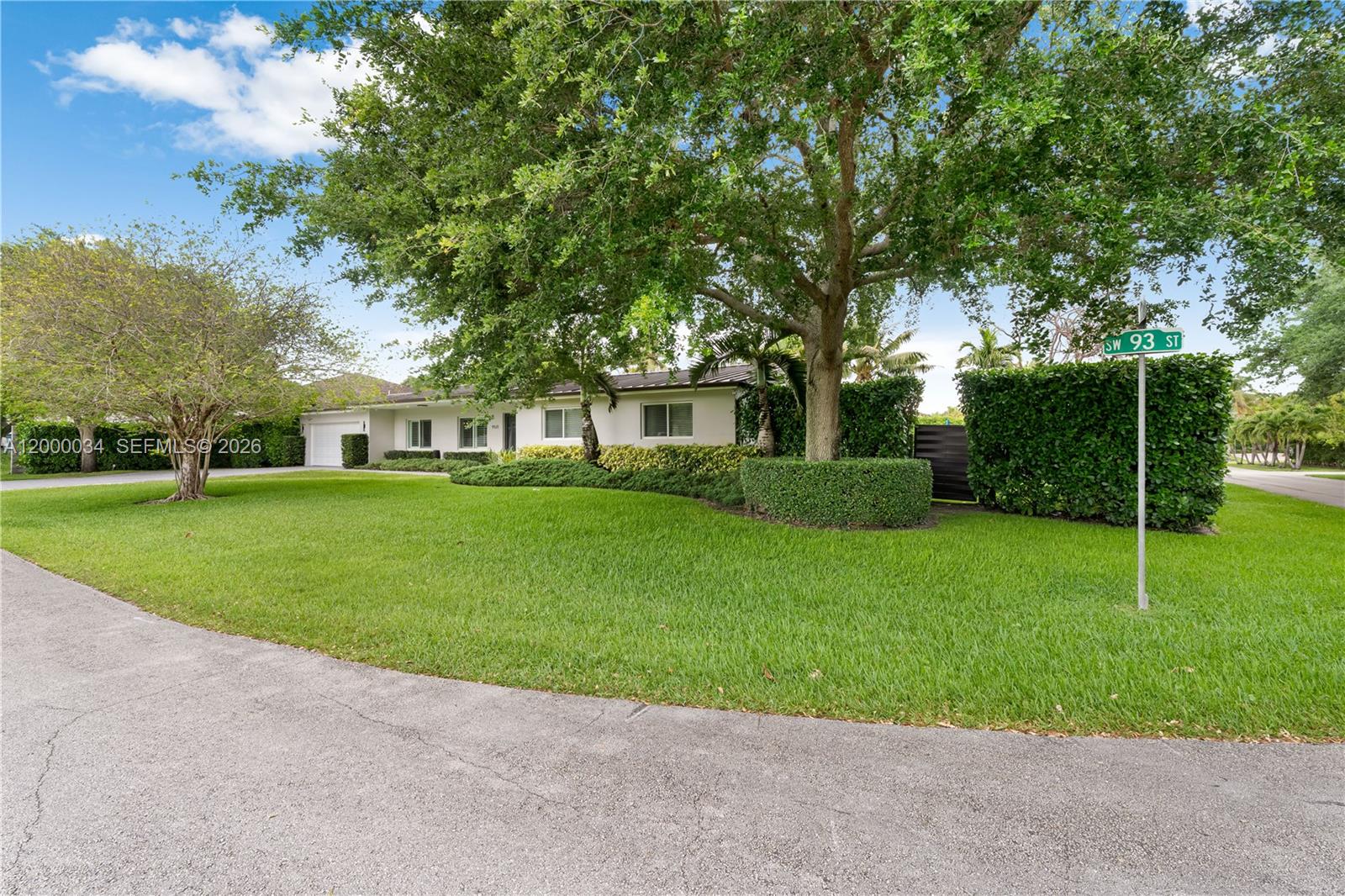 9511 Southwest 93rd Street Miami, FL 33176 - Photo 4 of 56 a view of a house with a big yard and palm trees