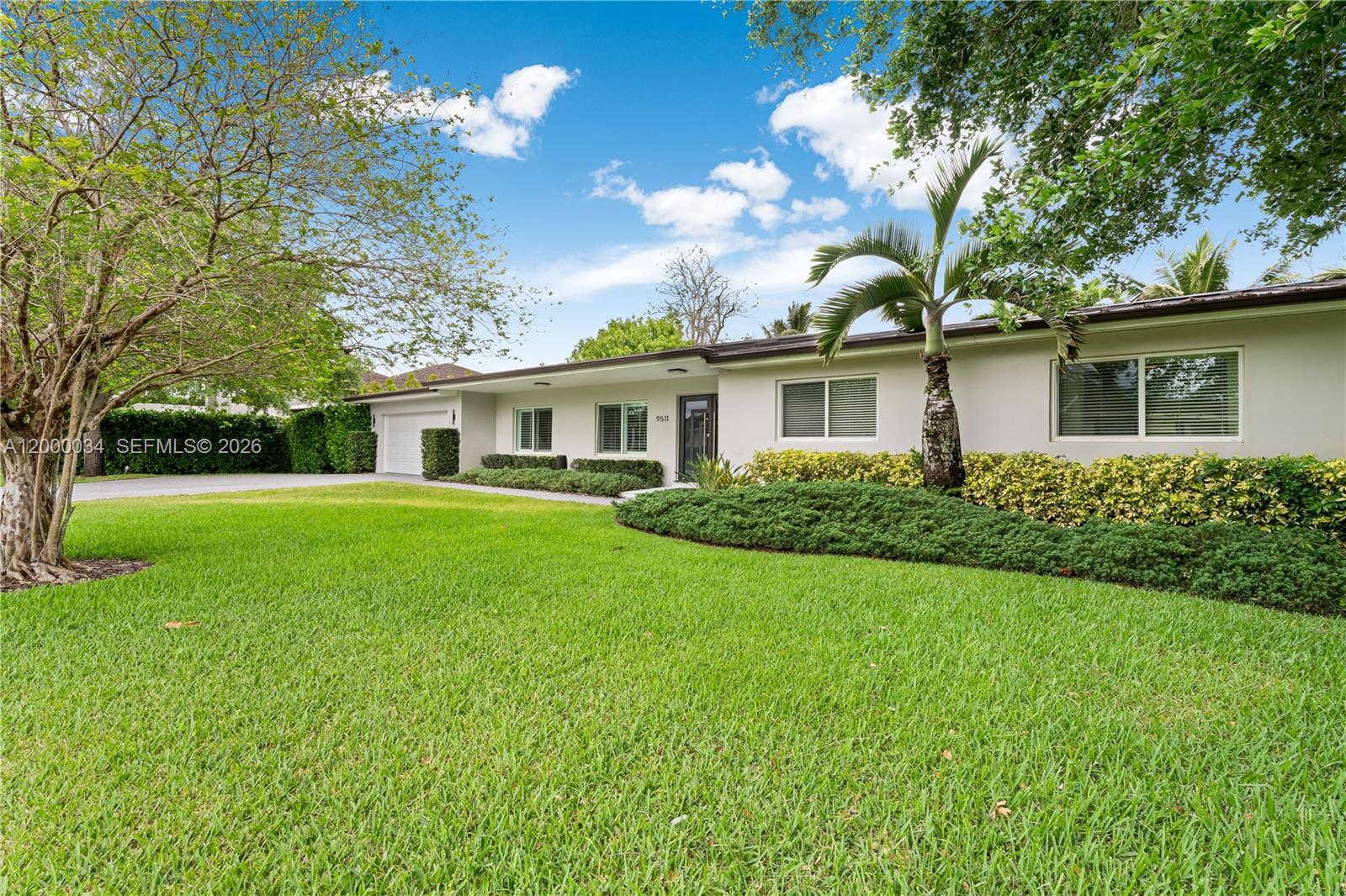 9511 Southwest 93rd Street Miami, FL 33176 - Photo 6 of 56 a view of house with a big yard and potted plants